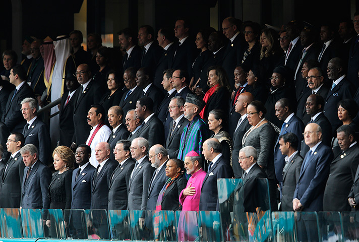 Memorial for Mandela: VIPs and dignitaries stand up for the start of the memorial service