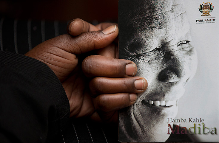Memorial for Mandela: A man holds the official programme before the memorial service 