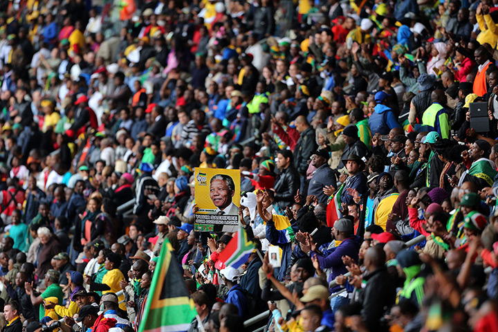 Memorial for Mandela: A man holds up a placard during the national memorial service