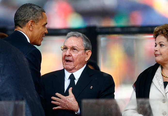 Memorial for Mandela: President Barack Obama greets Cuban President Raul Castro before giving his