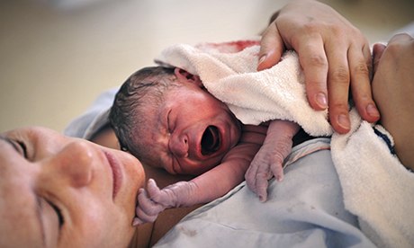 Newborn baby with his mother