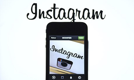 The Instagram logo is displayed on an smartphone