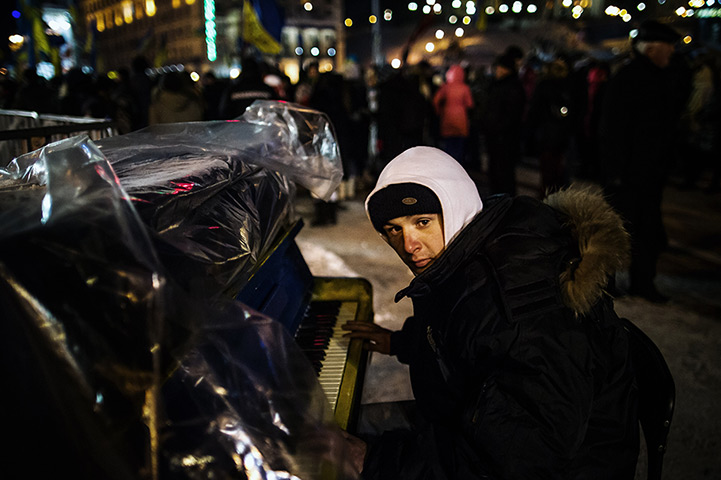 Ukraine update: A protester plays a piano in the tent camp at the Independence Square