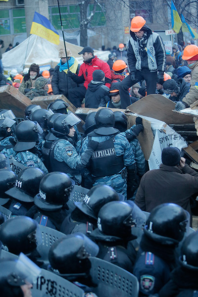 Ukraine update: Pro-European Union activists guard the barricade during clashes with riot p