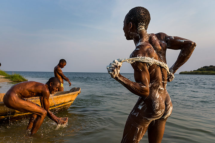 WWF Virunga Campaign: Men bathing in the Semliki River as it flows into Lake Edward