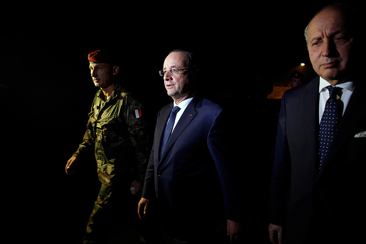 Central African Republic: French President Francois Hollande, centre, walks to his plane during a sto