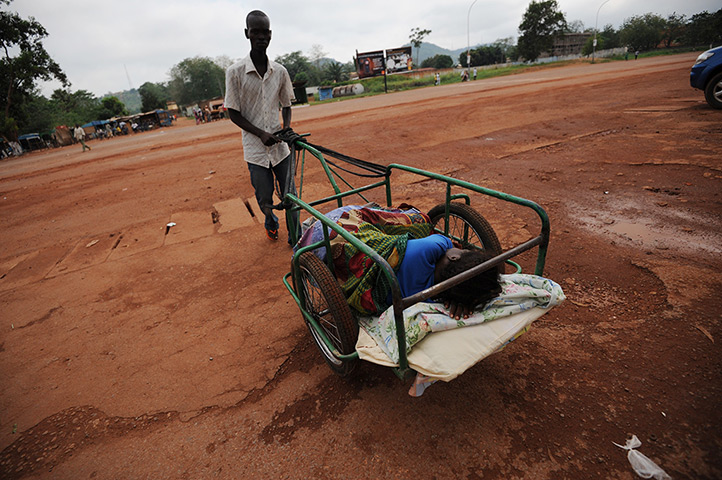 Central African Republic: A man pushes a wounded woman in a cart to an hospital of Bangui.
