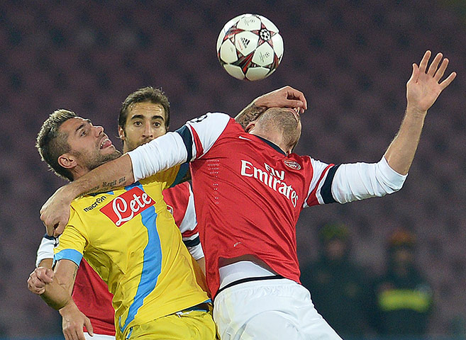 Napoli v Arsenal: Gokhan Inler gets stuck in with Olivier Giroud 