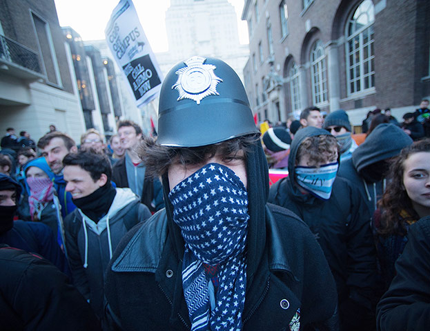 Cops off campus protest: protestor in a police hat cops of campus