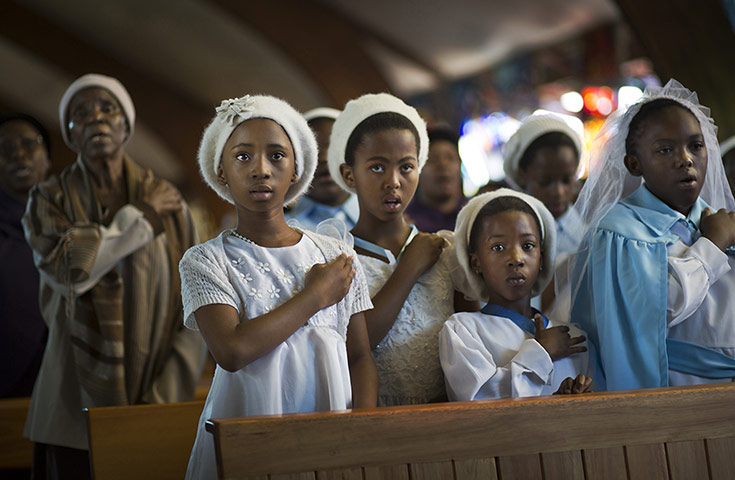 20 Photos: young members of a choir, at a morning mass in memory of Nelson Mandela