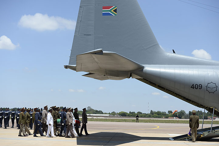 Qunu awaits: The coffin carried onto plane