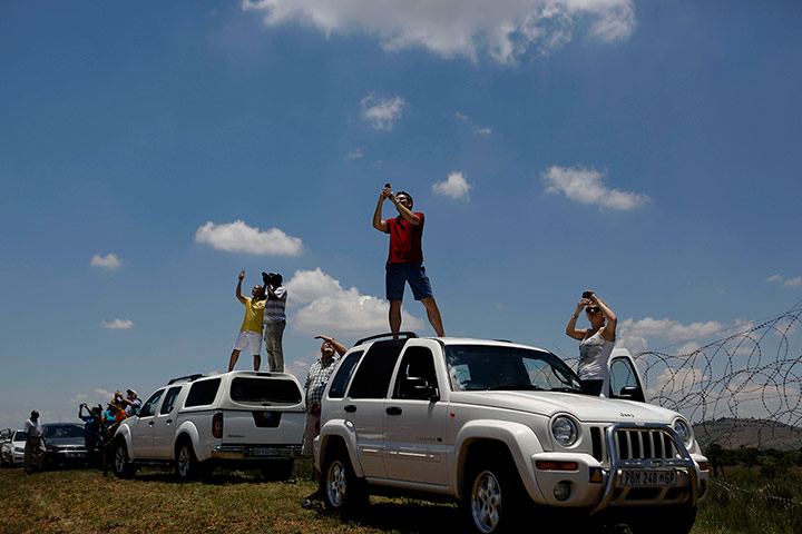 Mandela: People take photos of the aircraft carrying Nelson Mandela's coffin