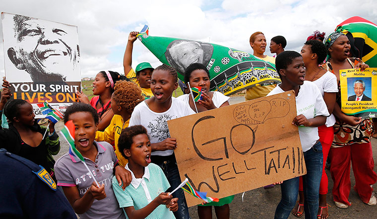 Mandela: Villagers sing and dance on the street while waiting for the funeral corteg