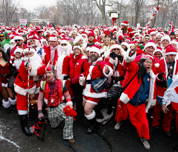 Revellers dressed as Santa Claus pose during SantaCon in New York