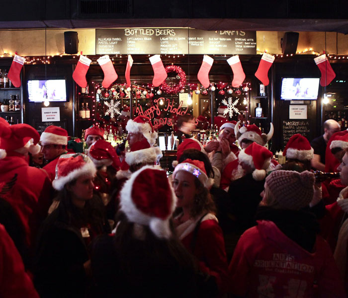 Revelers Dressed As Santa Take Part In Annual Bar Crawl Thru NYC