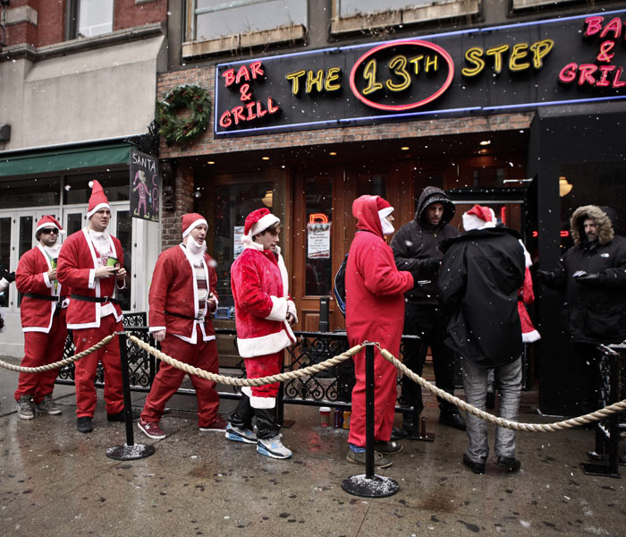 Revelers Dressed As Santa Take Part In Annual Bar Crawl Thru NYC