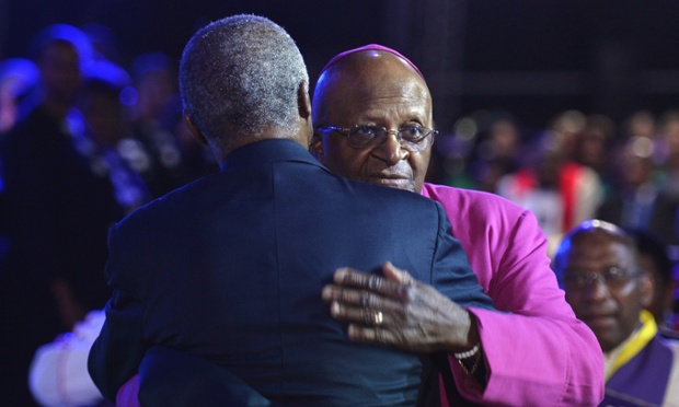 Archbishop Desmond Tutu, right is greeted by former South African president Thabo Mbekifor.