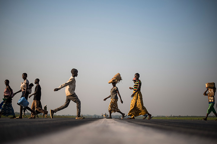 Weekend in pictures: Bangui, Central African Republic: People walk on an airport tarmac to reach