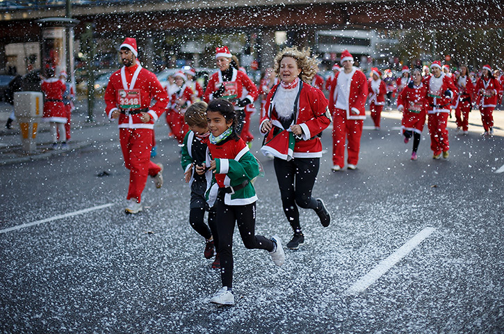 Weekend in pictures: Madrid, Spain: Participants run along Castellana Street during the Santa Cl