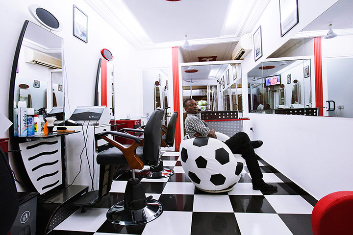 big picture - barbers: man in barber shop in Africa