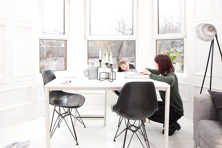 homes - glasgow house: woman and son sitting in white room with black chairs