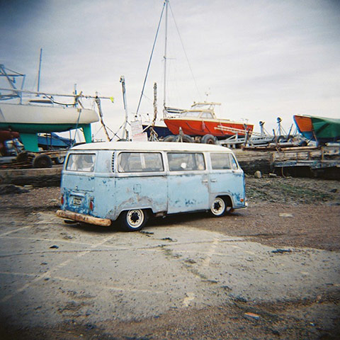 VW camper vans: old VW camper van parked near harbour