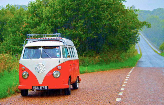 VW camper vans: red VW camper van parked in the rain