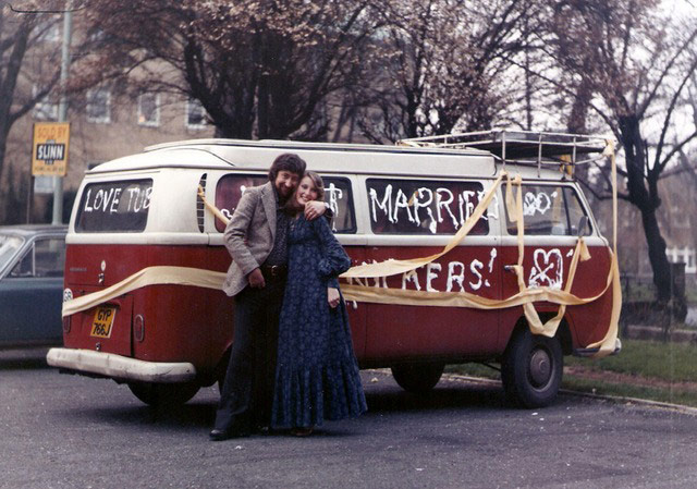 VW camper vans: married couple in front of VW camper 