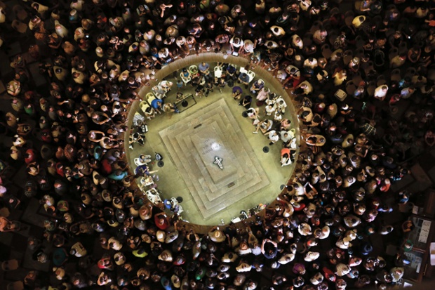 A bird's eye view shows visitors to the Voortrekker Monument watching as a ray of sunlight shines on the unmarked tomb in the monument during Day of Reconciliation celebrations in Pretoria in South Africa. 