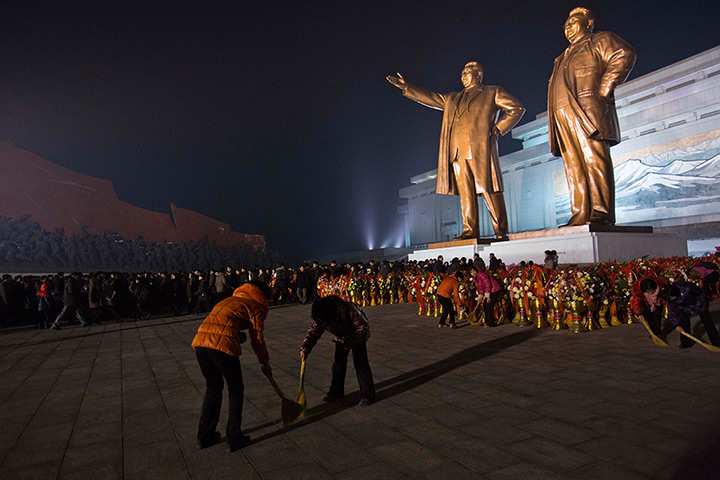 North Korea anniversary: Women sweep the base of statues of the late leaders in Pyongyang