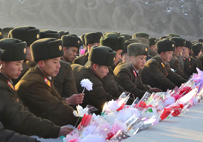 North Korea anniversary: North Koreans offer flowers in front of statues
