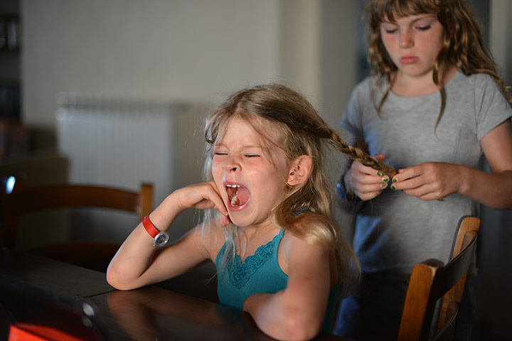 Your Pictures - pamper: two young girls in room, one girl plaiting hair of the other