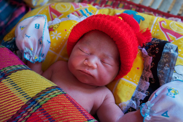 Your Pictures - pamper: small cambodian baby sleeping wearing red hat