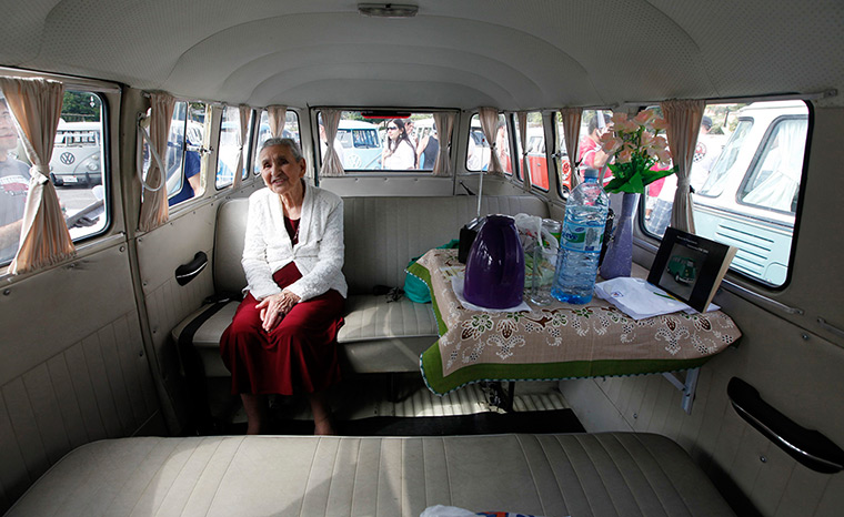 Volkswagen campers: Marcilia Coelho sits inside her van