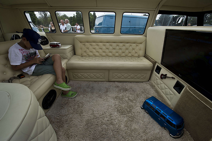 Volkswagen campers: A boy plays with a tablet inside a Kombi