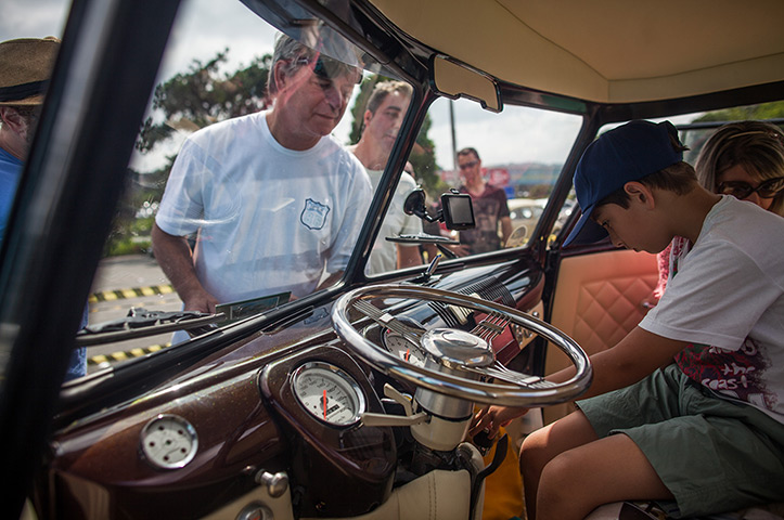 Volkswagen campers: Visitors inspects the interior of a custom Volkswagen Kombi minibus