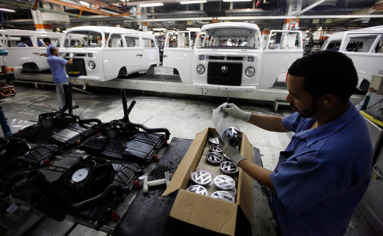 Volkswagen campers: VW badges arranged on the assembly line