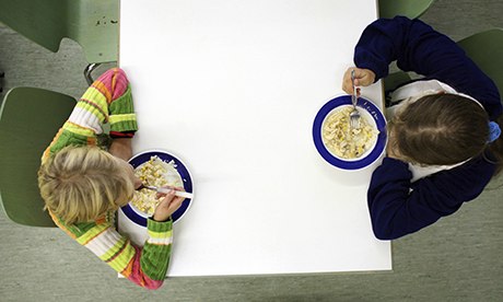 Children eat a meal at a soup kitchen for people on low incomes in Berlin