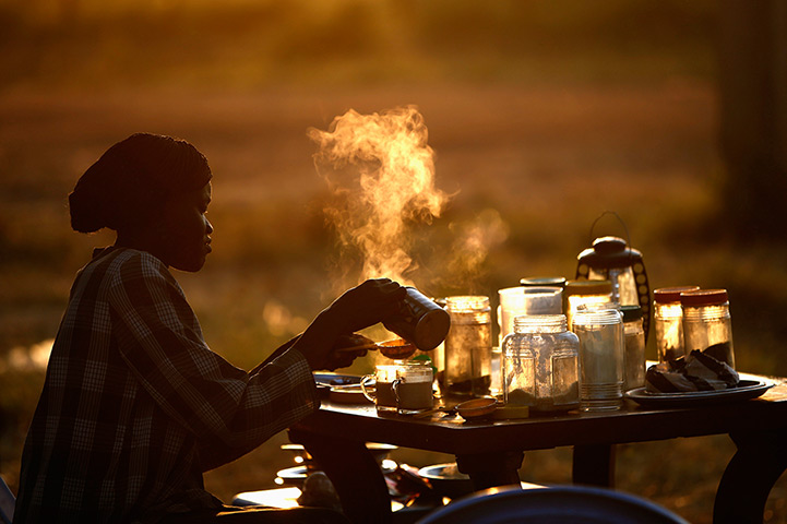 Goran Tomasevic: A woman prepares tea at an outdoor shop in the town of Abyei in October