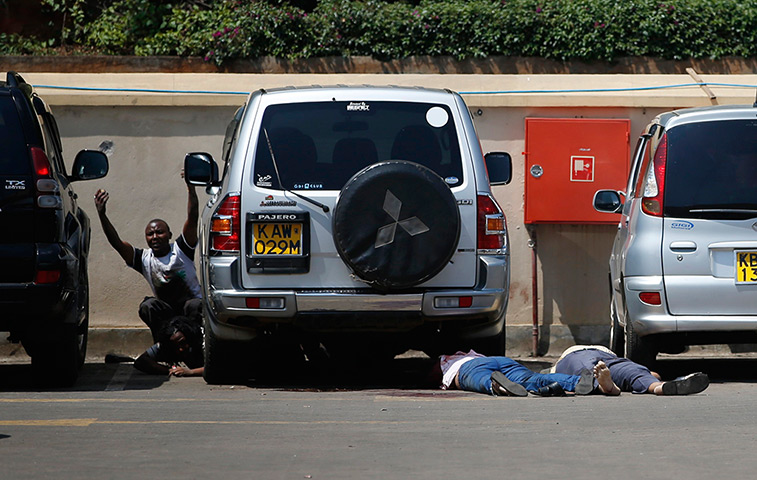 Goran Tomasevic: People come out from hiding under a car next to bodies in a car park as pol