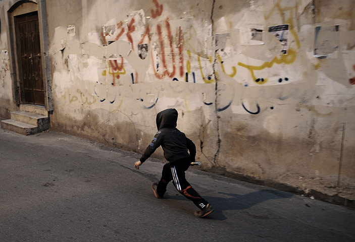 20 photos: A Bahraini boy holds a used tear gas canister