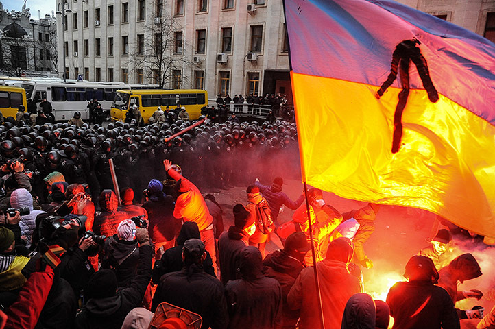Ukraine update: Protesters light flares as they continue to battle with riot police