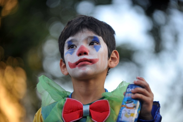 Christmas celebrations have begun with the Paris Parade watched by this little fellow, dressed for the occasion, in Santiago, Chile.