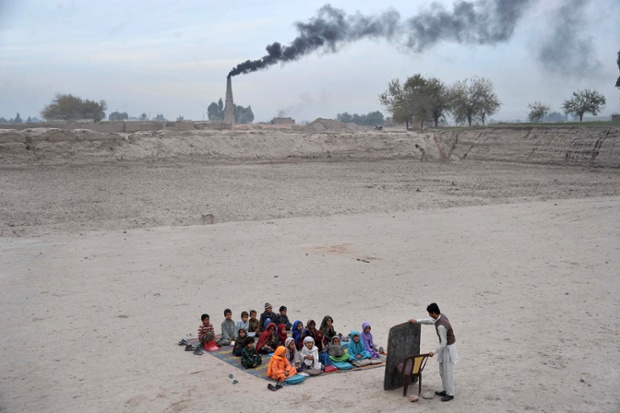 These Afghan schoolchildren have their lessons in an open classroom at a refugee camp on the outskirts of Jalalabad, in Nangarhar province. The education system throughout the country has been repeatedly undermined by decades of conflict and years of Taliban rule.