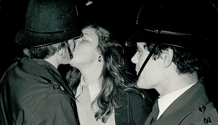 Looking back New Years: New Year reveller kissing a police man