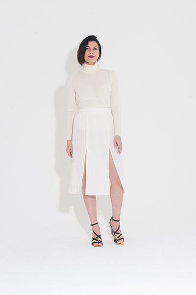 All Ages pleats: cream polo neck white pleated skirt gold strappy sandals