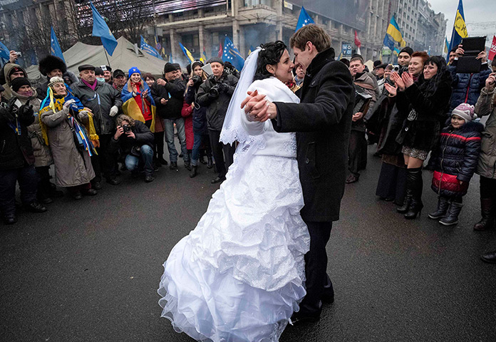 Weekend in pictures: Kiev, Ukraine: A bride and groom dance as they visit Independence Square wh
