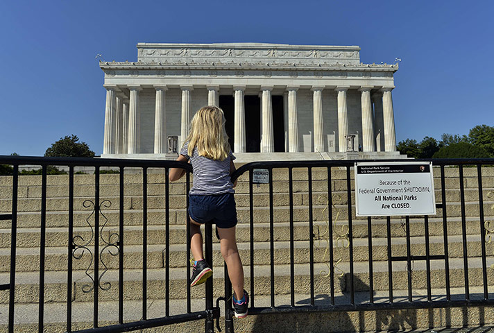 Business Review of Year: A child stands on the barricade around the Lincoln Memorial