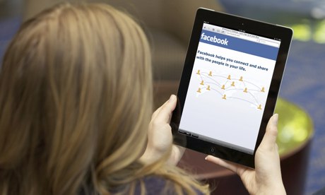A young woman using Facebook on an iPad