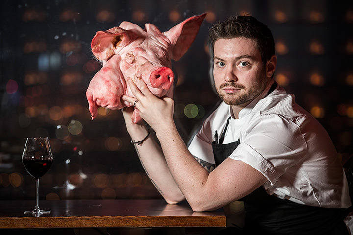 portraits of year: Head chef at restaurant Duck and Waffle,  Daniel Doherty, with a pig head a
